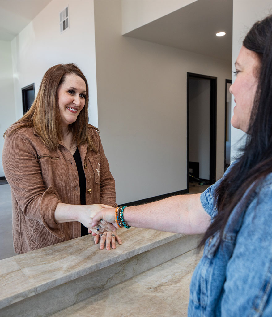 team member shaking Patients hand